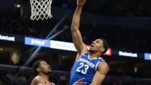 NBA defender mid-air blocking a shot at the rim, representing the defensive side of the best player debate