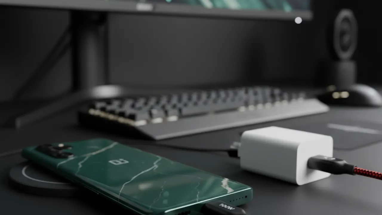OnePlus 13 Pro dark green smartphone with 100W fast charging cable plugged in on modern desk, representing best fast charging phone 2026